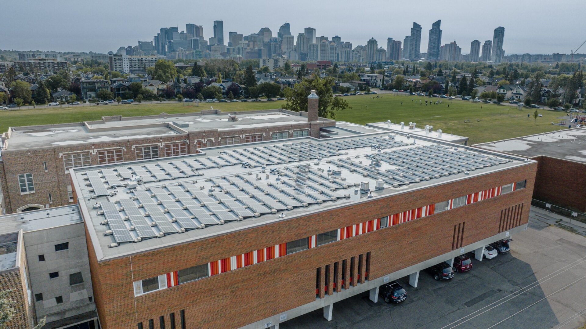 Aerial view of a commercial rooftop solar panel installation in Calgary.