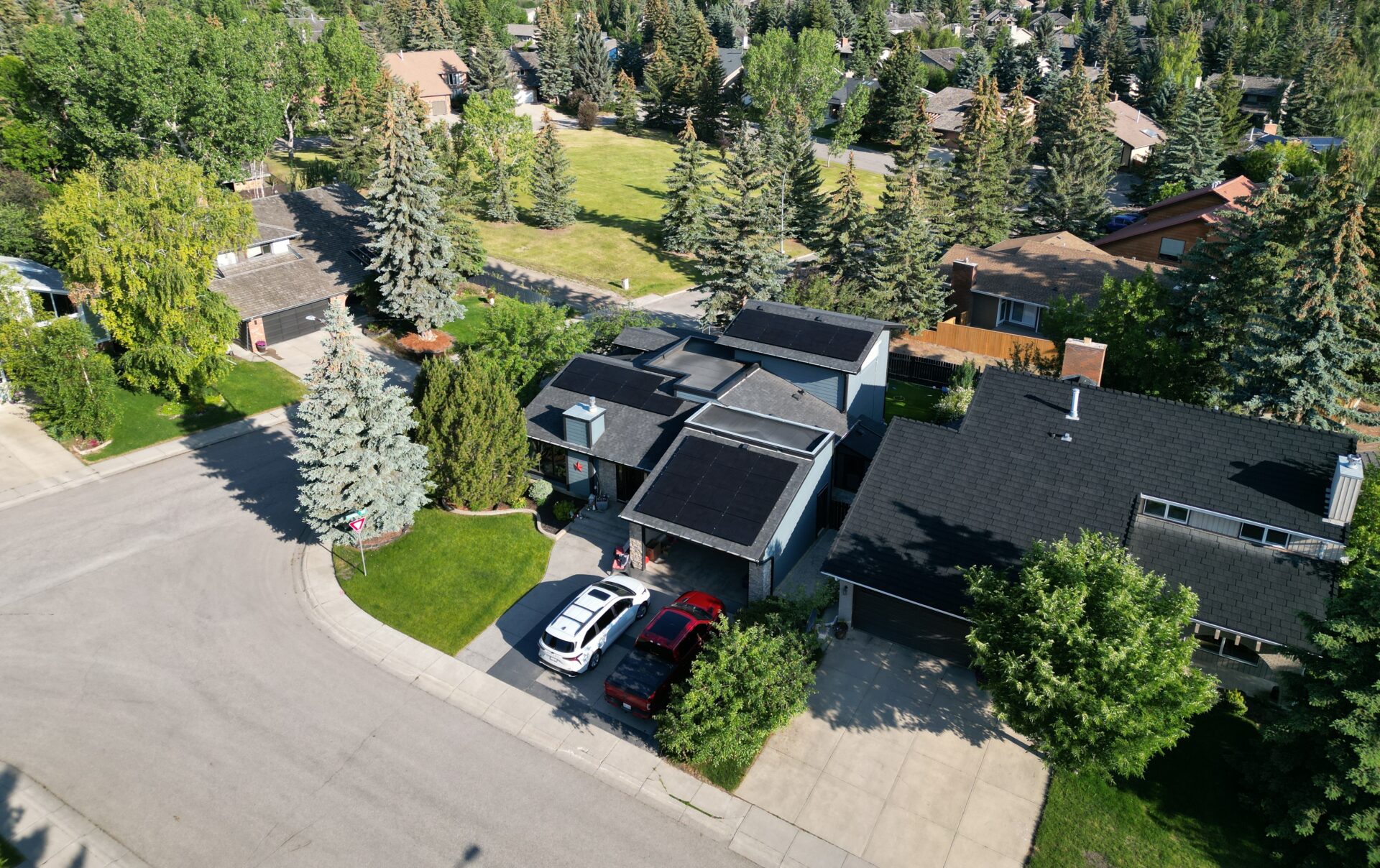 Aerial view of a Calgary residential neighborhood with solar panels on roofs.
