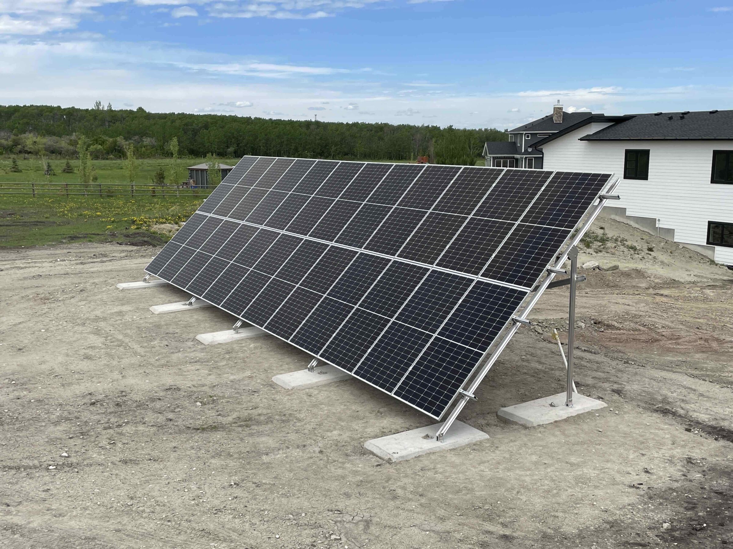 Large residential ground-mount solar panel array installed on a concrete foundation by Rocky Mountain Solar Co.