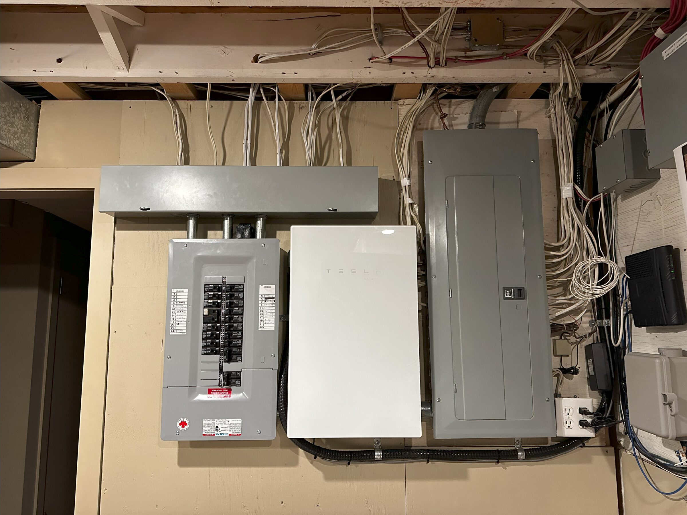 Interior Tesla Powerwall Calgary installation showing Gateway 2 and backup electrical panel.
