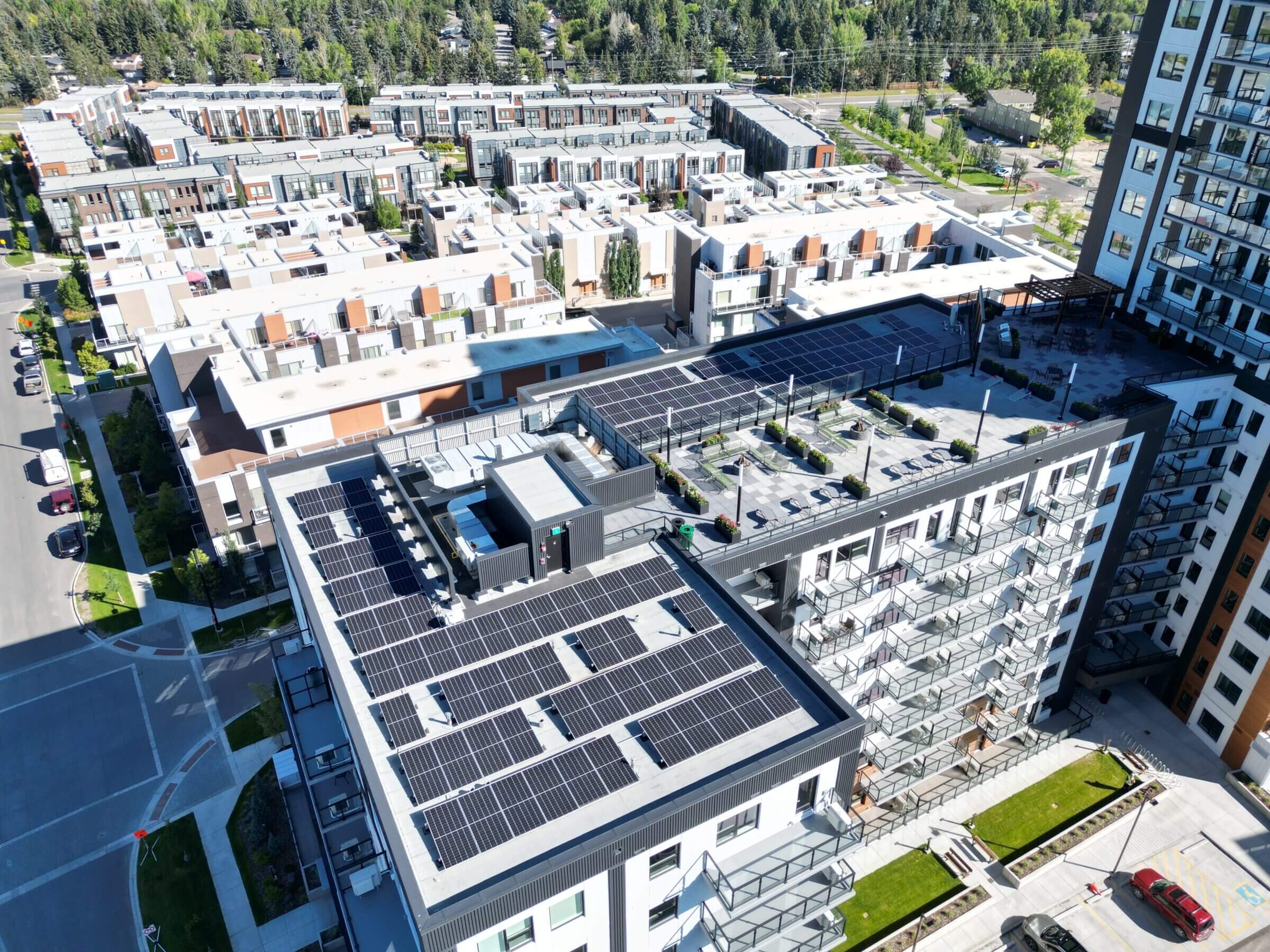 Aerial drone view of a large-scale industrial flat-roof solar panel installation by Rocky Mountain Solar Co.
