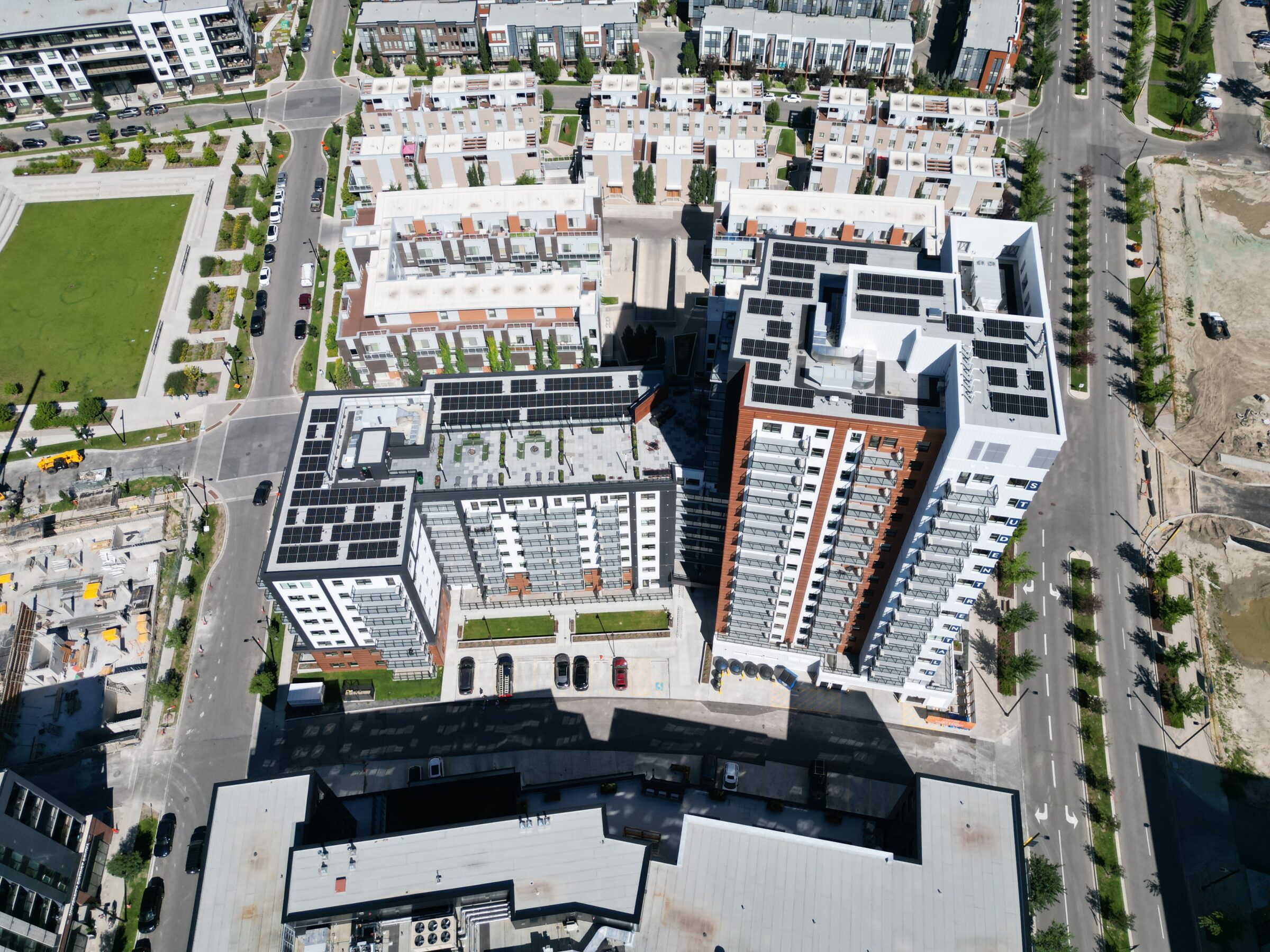 Professional commercial solar panel installation on a flat roof by Calgary solar installers