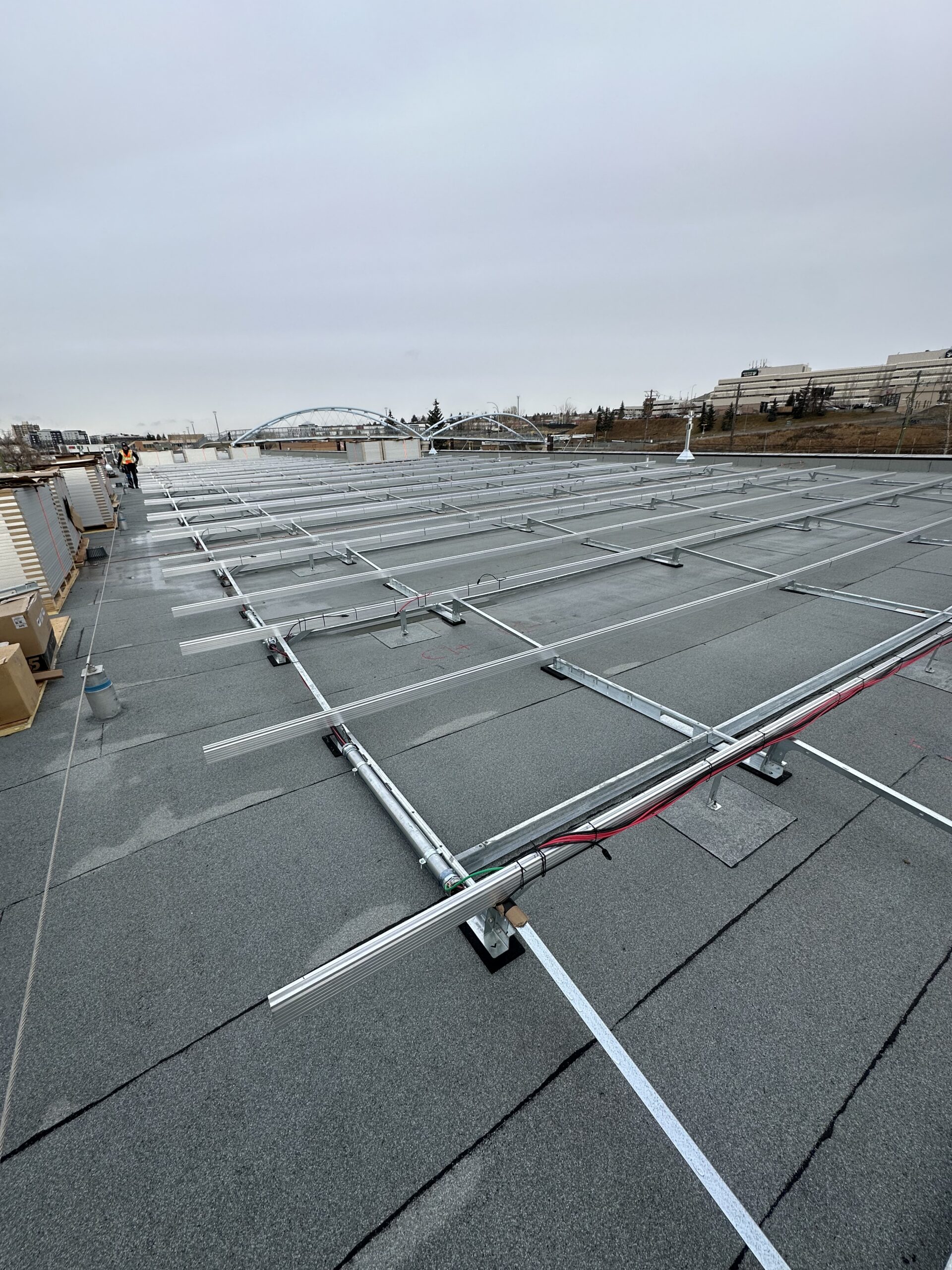 Large-scale commercial solar panel rows at the Haysboro LRT station in SE Calgary by Rocky Mountain Solar Co.