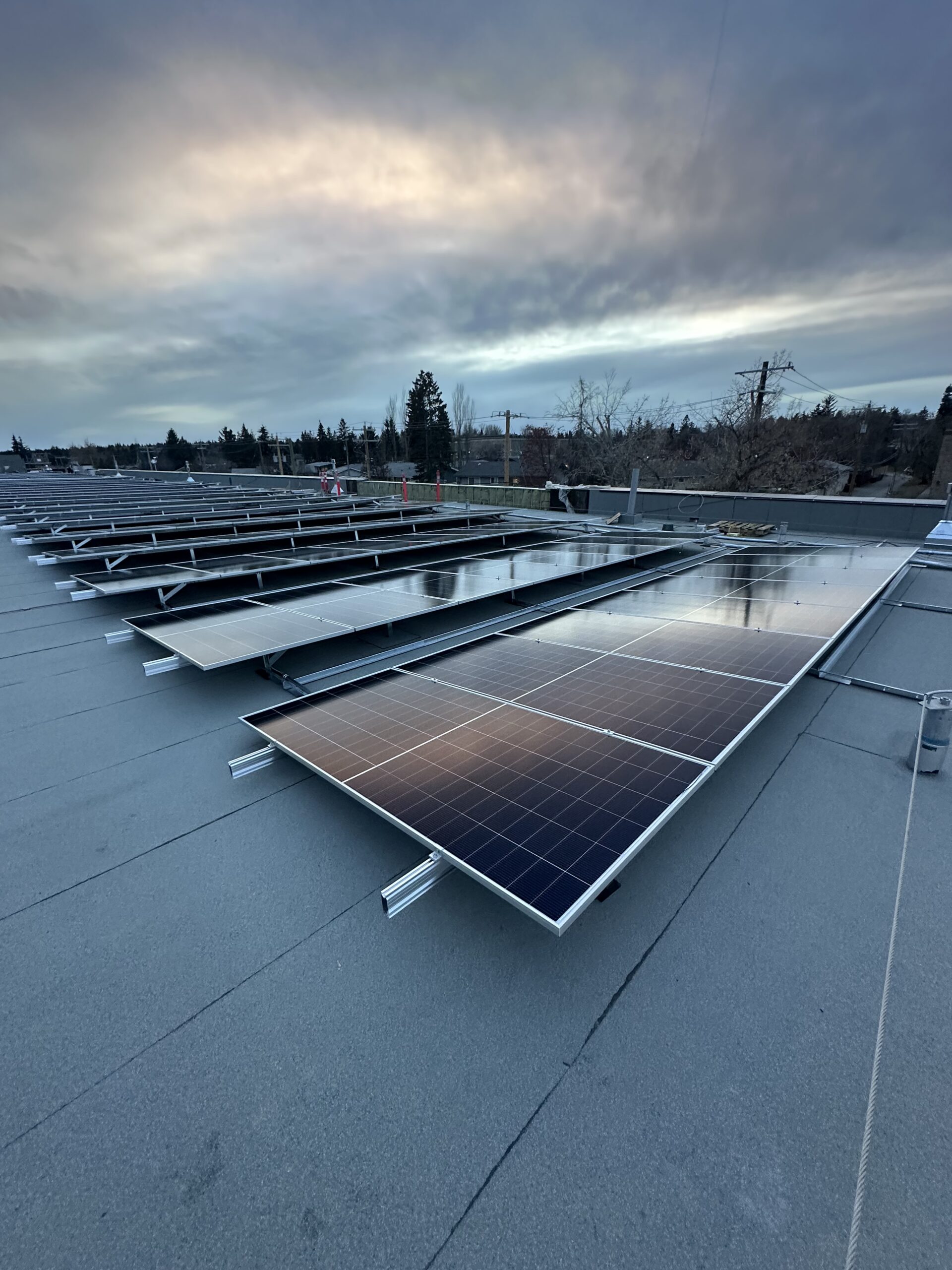 Close-up of integrated commercial solar racking on an IKO Diamond Shield roof at the Haysboro LRT station in Calgary.