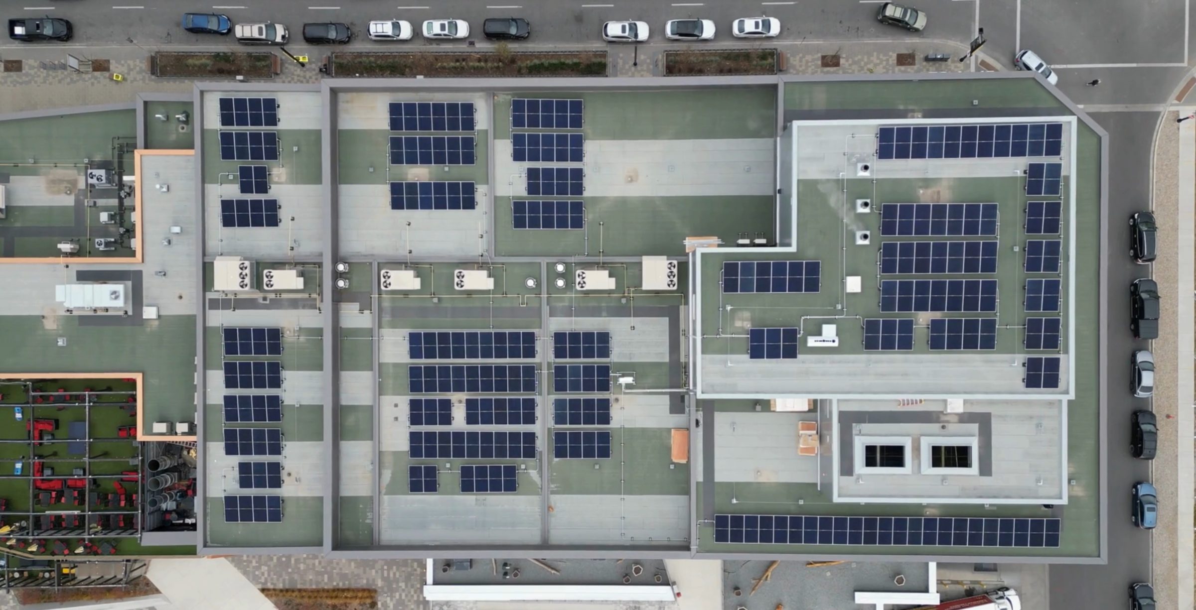 Aerial view of a large commercial rooftop solar panel installation in Calgary, demonstrating clean energy solutions.